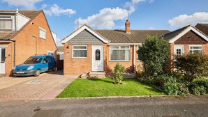 A row of two-story houses with a blue car parked in the driveway. - Host Stay Sands Walk Cottage (Redcar)