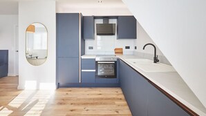 A modern kitchen with a built-in oven, a microwave, and a sink. - Host Stay Apartment 4 Fourth Avenue (York)