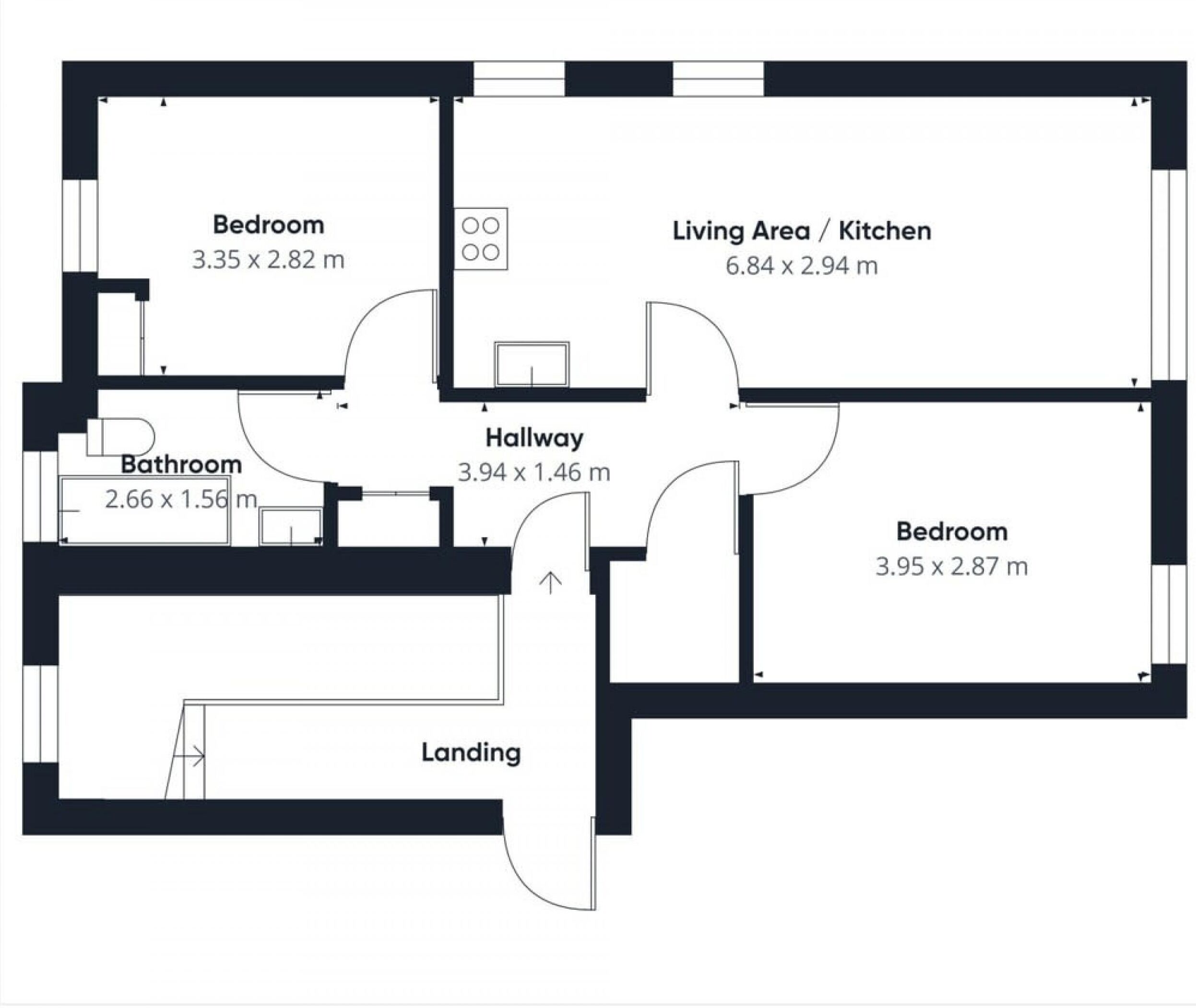 A floor plan with two bedrooms, a bathroom, a living area/kitchen, a hallway, and a landing.