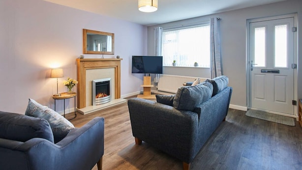 A living room with a fireplace, a television, and a sofa. - Host Stay Station View (Saltburn-by-the-Sea)