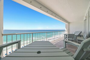 A balcony with a view of the ocean, a wooden deck, and outdoor seating. - 2 bedroom, 2 bath Gulf-front condo! (Destin)