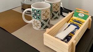 A coffee maker, two mugs, and a box of biscotti on a table. - Il Buon Risveglio Agropoli (Agropoli)