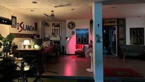 A hotel lobby with a reception desk, seating area, and a door labeled "LANDA". - Cocoon Islanda Hotel (Patong)