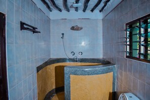 A bathroom with a bathtub, a shower, and a toilet.