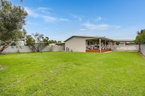 A single-story house with a covered patio, a fenced yard, and a clear blue sky. - Where the River meets the Sea 66 Colman Rd Goolwa-No Linen Included (Goolwa South)