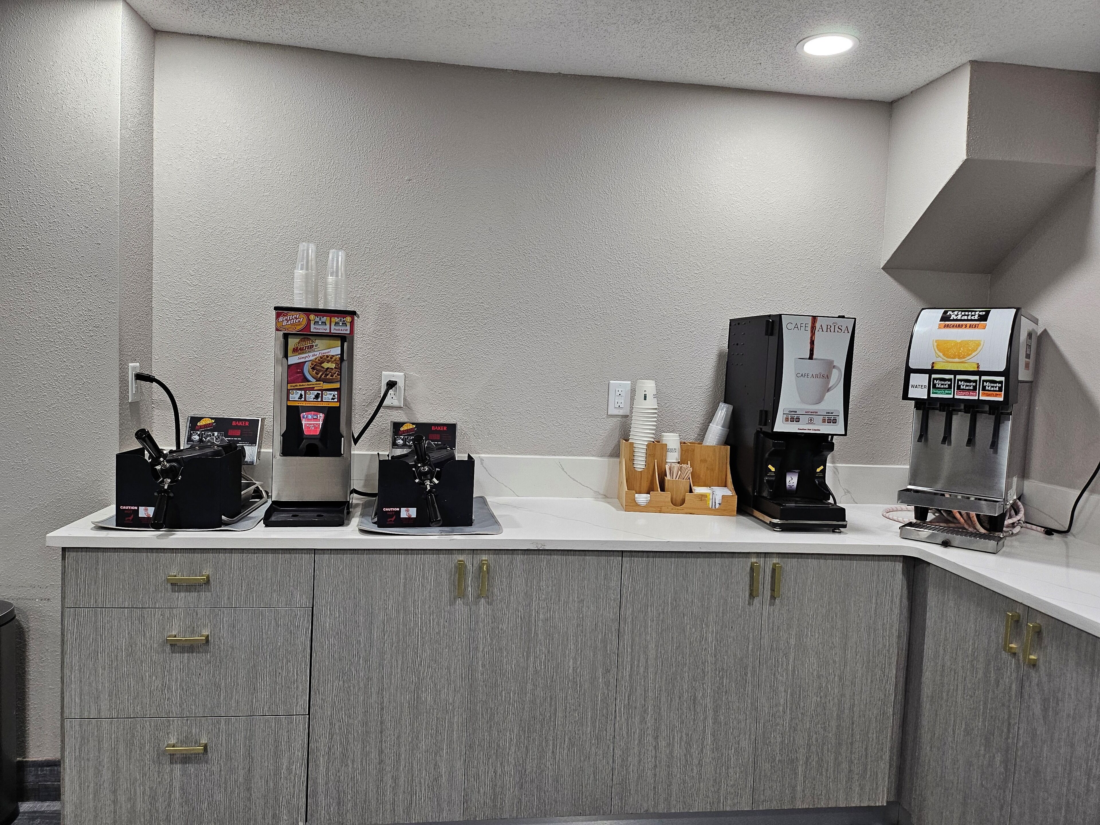 A coffee station with multiple coffee machines and a bakery display.