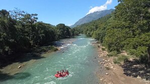 A river with clear water, surrounded by dense green forest and mountains in the background. - Room in Cabin - Rafting Hut by The River (San Agustin Lanquin)
