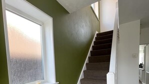 A staircase with carpeted steps leading to a landing. - 3 bed House in Blackpool With Cinema & hot tub (Blackpool)