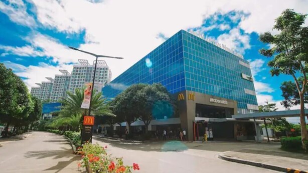A modern building with a glass facade and a McDonald's sign.