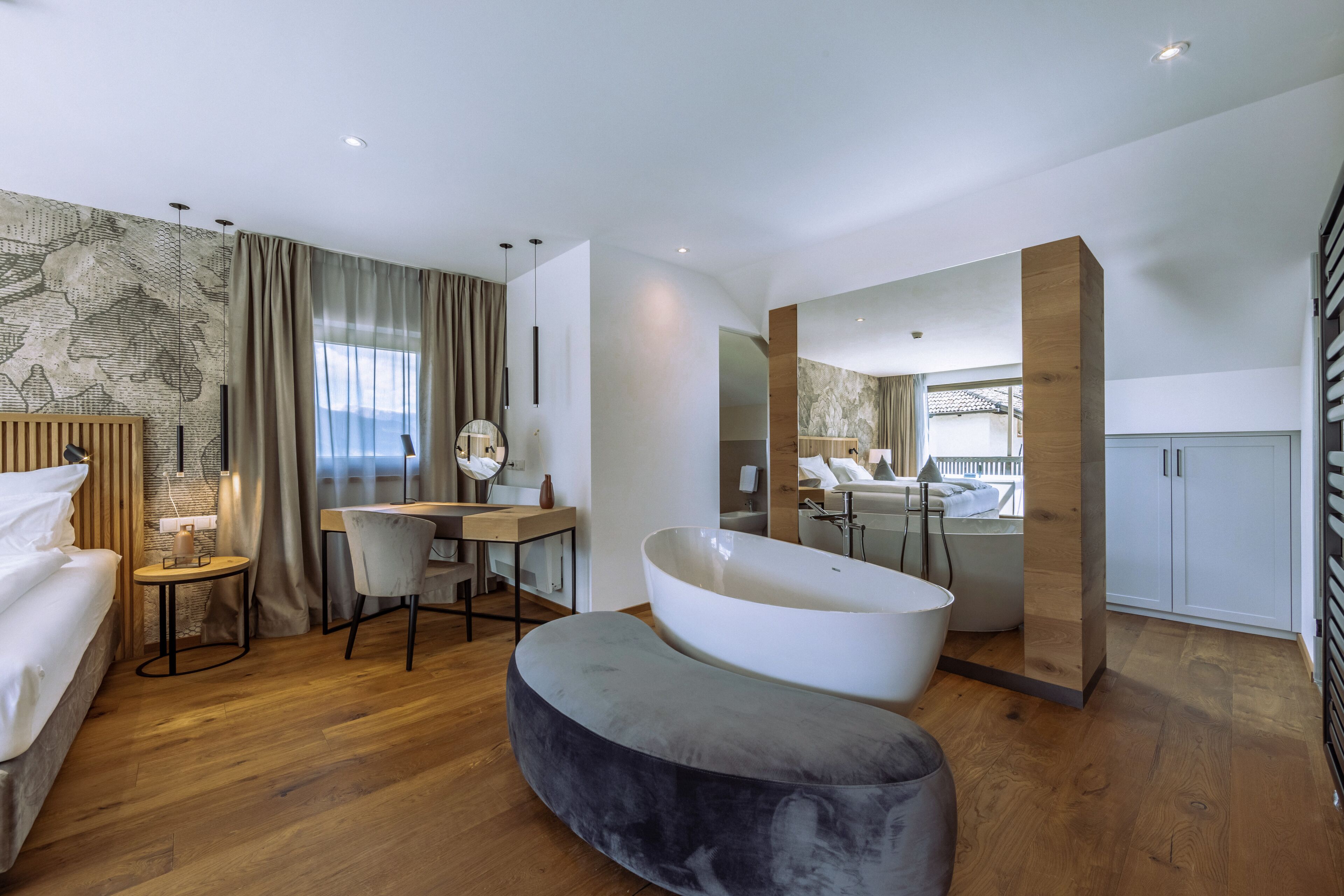 A modern bathroom with a freestanding bathtub, a vanity with a mirror, and a shower area.