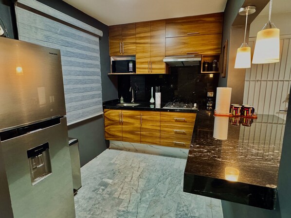 Fridge, microwave, stovetop, coffee/tea maker