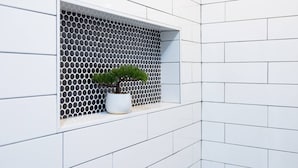 A modern bathroom with white tiled walls and a window with a honeycomb pattern. - Saragossa Sunshine Unit B (St. Augustine)