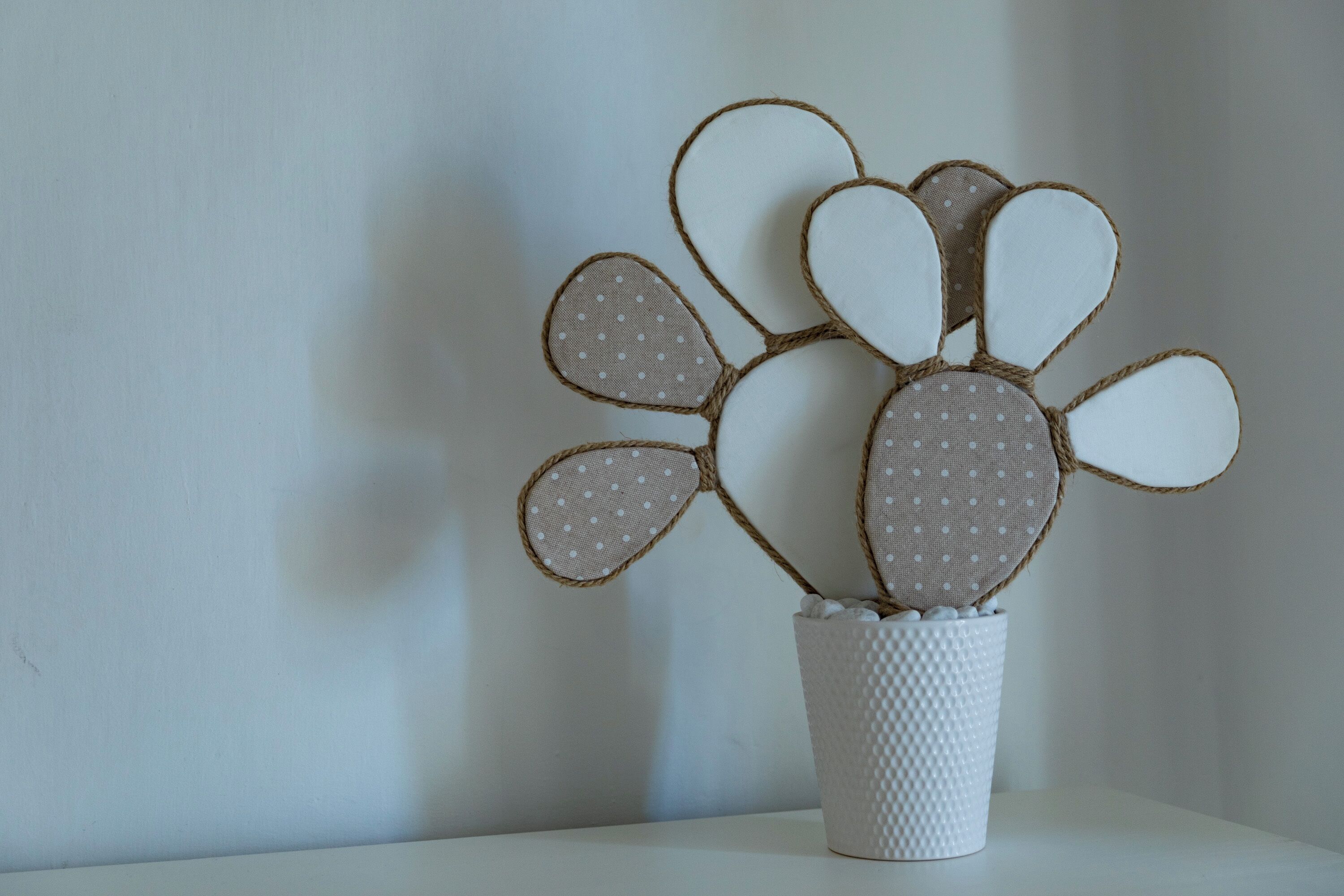 A white textured vase with a decorative bunny design.