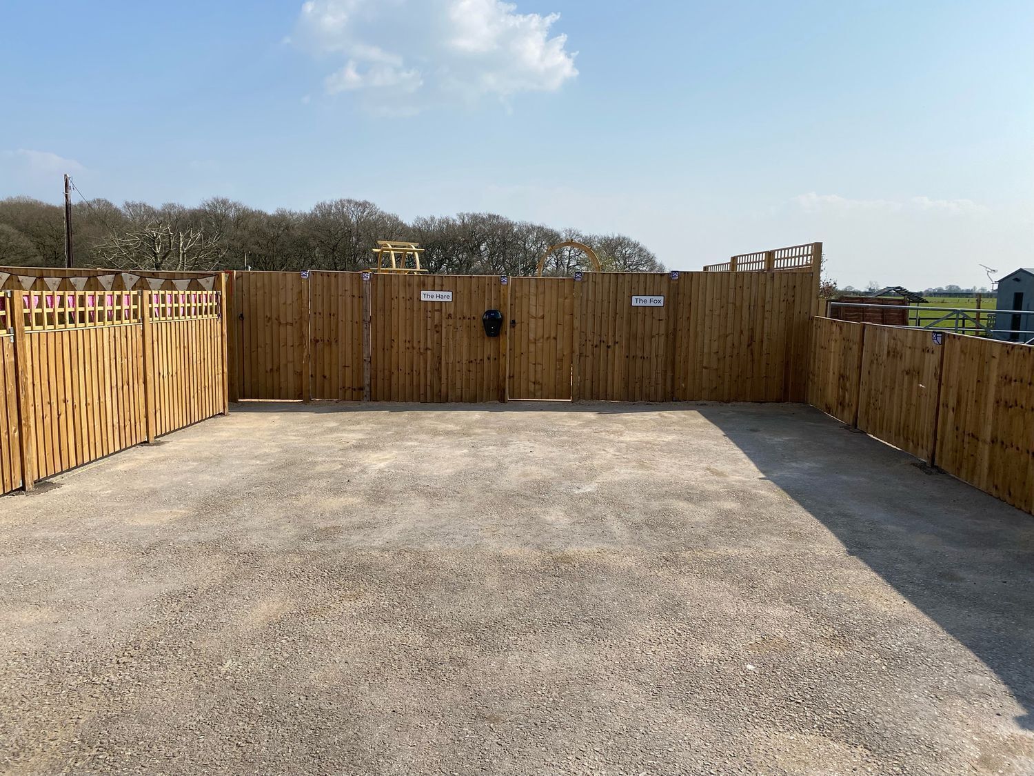 A fenced outdoor area with two gates labeled "The Hare" and "The Fox".