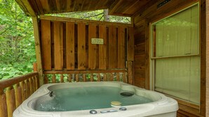 A wooden cabin with a hot tub. - A Gatlinburg Game House For 6 (GATLINBURG)