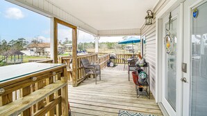 A covered deck with a pool table, outdoor seating, and a grill area. - Waterfront Bay St Louis Home w/ Private Dock! (Bay St Louis)