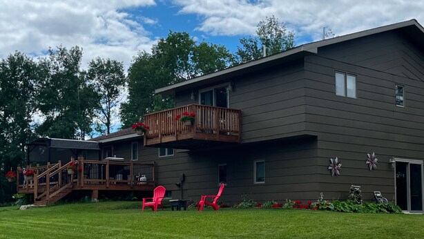 A modern two-story house with a balcony, a deck, and a garage. - Large  fully furnished,centrally located northern Minnesota retreat . (Embarrass)