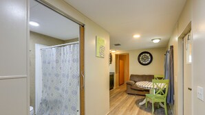 A compact living space with a bathroom, a dining area, and a living room. - Cottage on 80-Acre Farm near WEC & Devil's Den (Morriston)