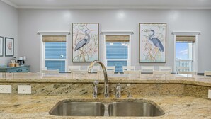 A modern kitchen with granite countertops, stainless steel sinks, and pendant lighting. - Beachfront Private Home 5 BR 4.5 Bath Pet Friendly (Port Saint Joe)