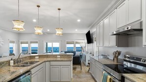 A modern kitchen with granite countertops, stainless steel appliances, and a large island. - Beachfront Private Home 5 BR 4.5 Bath Pet Friendly (Port Saint Joe)