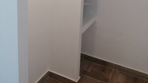 A closet with built-in shelves and a light strip above the door. - Room in Guest Room - 12 Senses Faliraki Deluxe Room Near Sea 1 (Rhodes)