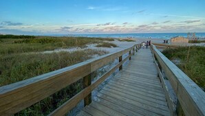 A wooden boardwalk leading to a beach with a clear sky. - Cocoa Beach 2 BR 2 Bath Condo Ocean View & Balcony (Cocoa Beach)