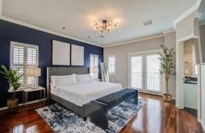 Primary bedroom with king bed and velvet bench