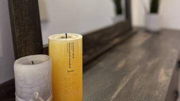 A candle holder with a candle on a wooden surface.