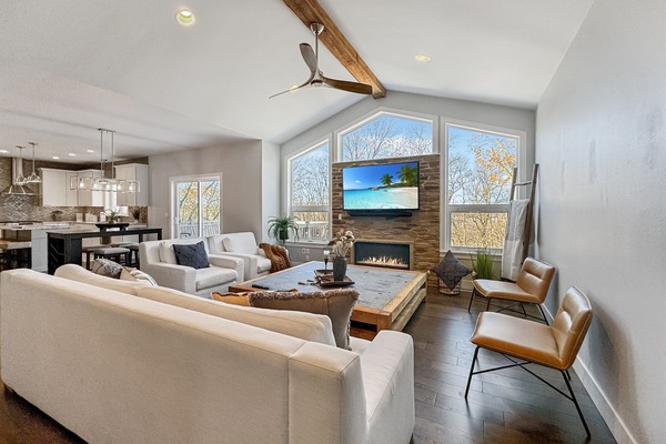 Living room on main complete with smart TV, gas fireplace and ample seating.