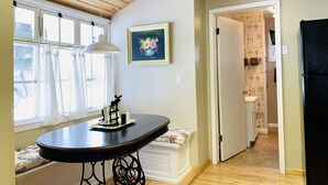 A kitchen with a black refrigerator, a wooden ceiling, and a window with curtains. - In-Town Home, Hot Tub, Wifi & Minutes to Skiing (Red Lodge)