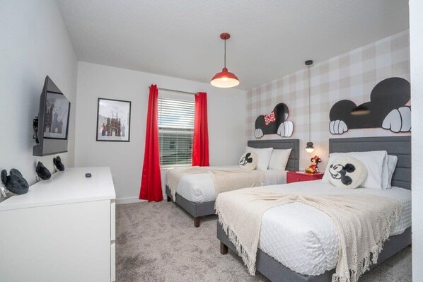 A bedroom with two beds, a desk, and a window with red curtains. - Magnificient 4Bd W/ Pool @ Storey Lake Resort 2648 (Kissimmee)