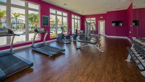A gym with treadmills, elliptical machines, and weight benches. - Marvelous 4 Bd Close To Disney At West Lucaya 8959 (Kissimmee)