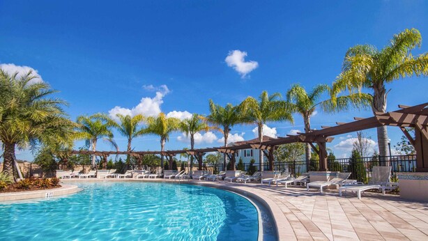 A swimming pool with a 4 FT depth marker, surrounded by lounge chairs and palm trees. - Marvelous 4 Bd Close To Disney At West Lucaya 8959 (Kissimmee)