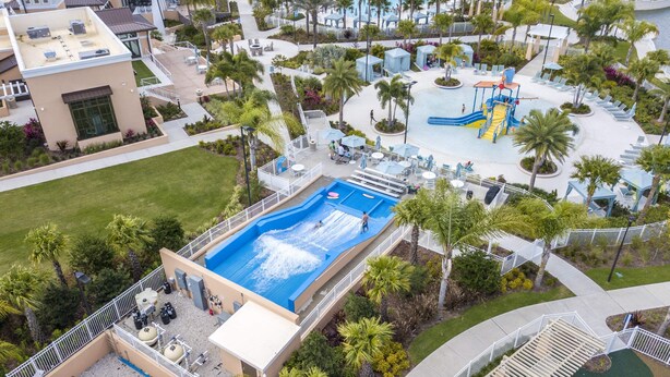 An aerial view of a resort with a large swimming pool, lounge areas, and a water slide. - Splendid 6Bd W/ Pool At Solara Resort 2154 (Kissimmee)
