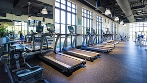 A gym with treadmills, exercise bikes, and other fitness equipment. - Splendid 6Bd W/ Pool At Solara Resort 2154 (Kissimmee)
