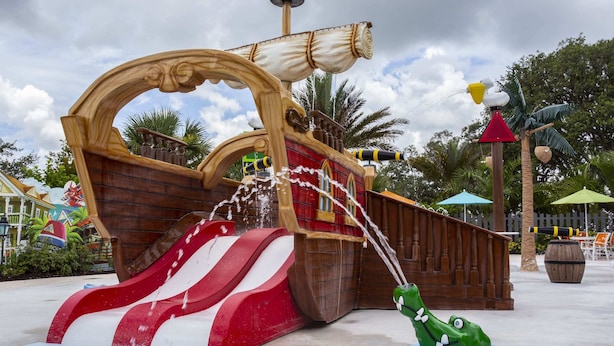 A pirate-themed water play area with a ship structure, slides, and a crocodile float. - Stunning 3Bd With Game Room @ Enclaves Resort 1021 (Davenport)