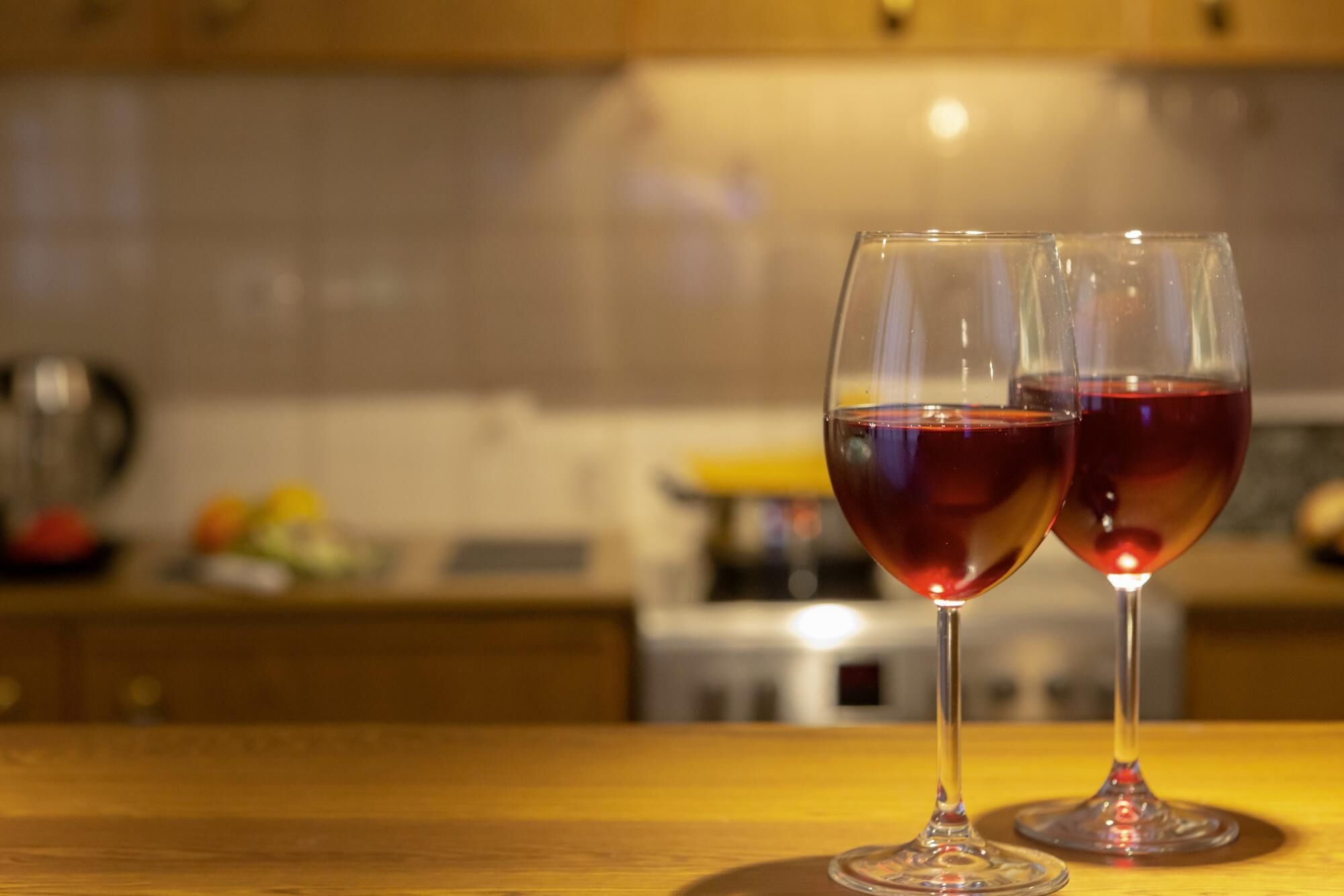 Due bicchieri da vino su un tavolo di legno in cucina.