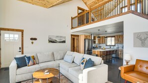 A spacious living area with a large L-shaped sectional sofa, a round coffee table, and a wooden ceiling. - 'Meadowlark Mountain Club' w/ Views of the Rockies (Jefferson)