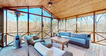 Lakefront retreat with screened sunroom, wood stove, multiple decks, & AC