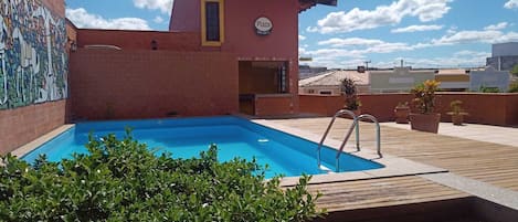 Outdoor pool, open 6:00 AM to 10:00 PM, pool umbrellas