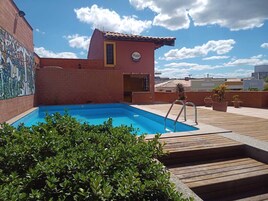 Outdoor pool, open 6:00 AM to 10:00 PM, pool umbrellas