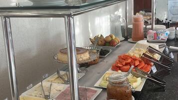 A buffet setup with various food items and utensils.