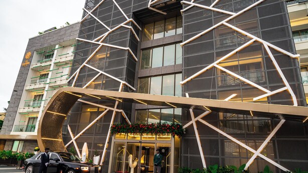 A modern building with a geometric facade, large windows, and a welcoming entrance with a red carpet. - The Delborough Lagos (Lagos)