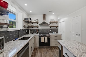 Bright modern kitchen with granite counters and stainless appliances