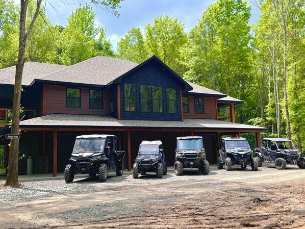 A two-story building with a covered parking area. - Hit the trail from the property! Game room, fire pit and 4 king suites (Muse)
