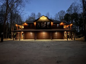 A large, two-story house with a prominent garage and a covered porch area. - Hit the trail from the property! Game room, fire pit and 4 king suites (Muse)