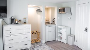 A compact kitchen with white cabinetry, a microwave, a coffee machine, and a small refrigerator. - Second floor ocean views w/ kitchenette private deck! (Hampton)