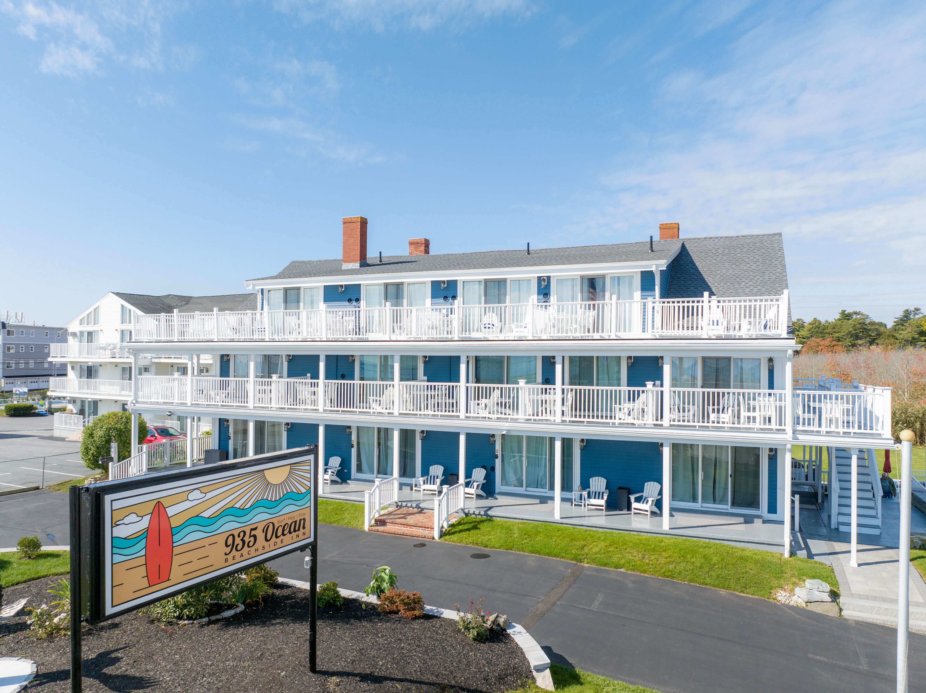 A multi-story beachfront hotel with a sign indicating it is the 935 Ocean Beachside Inn.