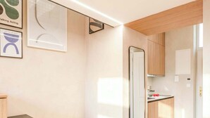 A modern kitchen with wooden cabinets, a built-in oven, and a countertop.