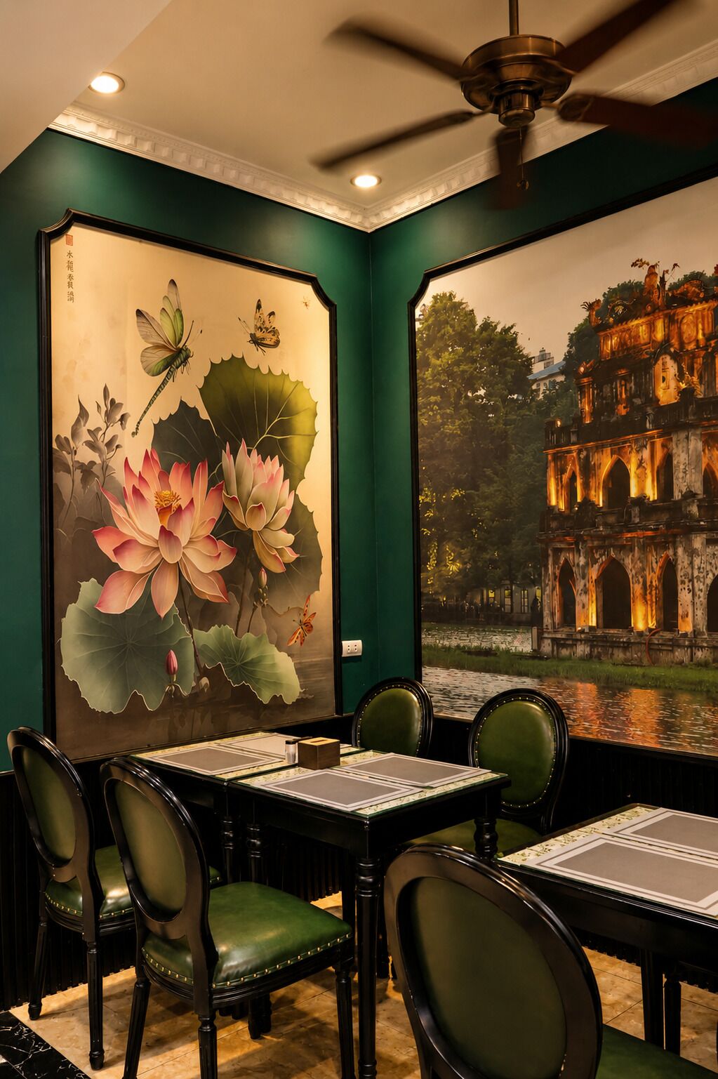 A restaurant with a traditional Chinese mural, a ceiling fan, and a view of a historic building through a large window.